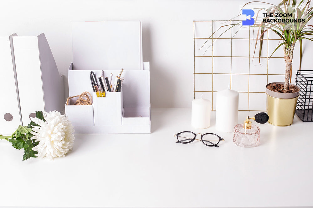 office with cute feminine items on white table zoom background