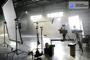 focused studio camera and equipment silhouette behind shooting zoom ba