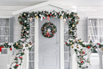 white christmas front door with wreath in snow zoom background